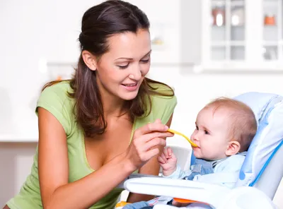 Mom feeding healthy baby