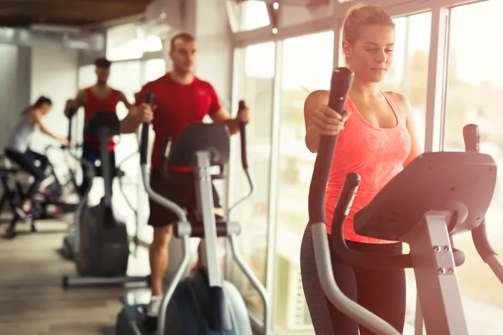 women strengthening arms on the elliptical machine