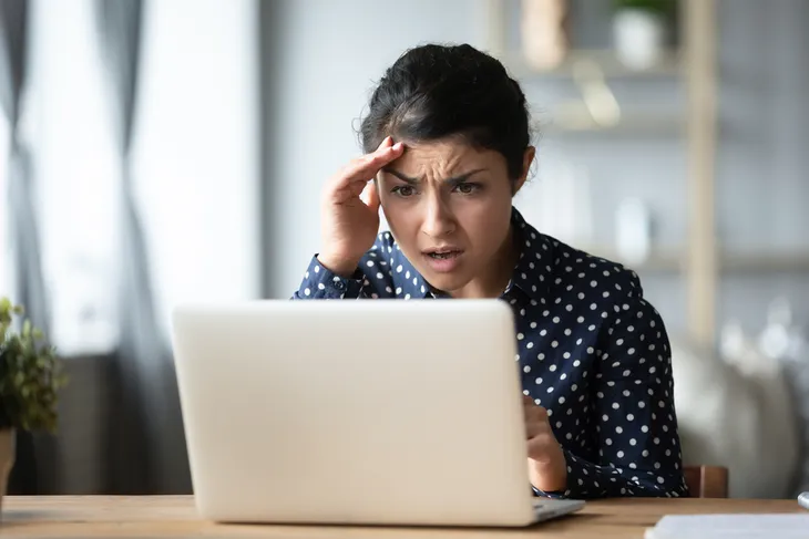 Woman stressed looking at her computer