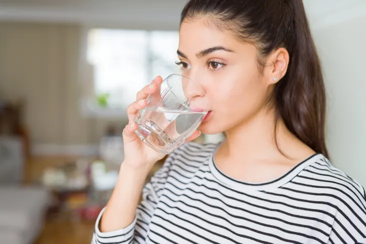 Woman drinking water out of a glass