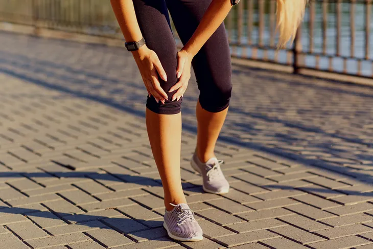 Woman with sore knee joint