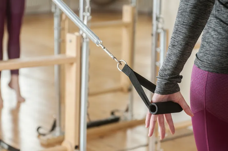 Woman using pilates equipment