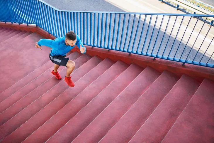 Mature man running up stairs