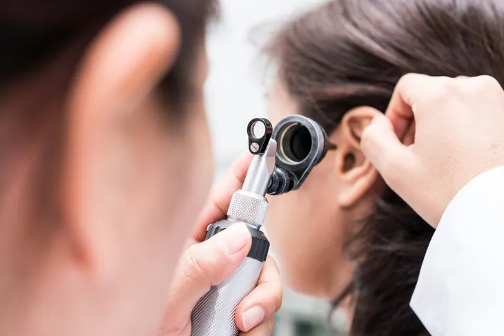 Doctor checking ear