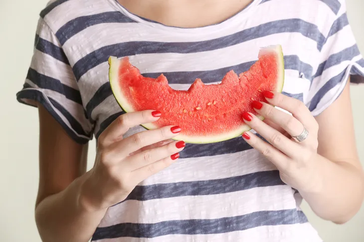 Woman holding a watermelon wedge