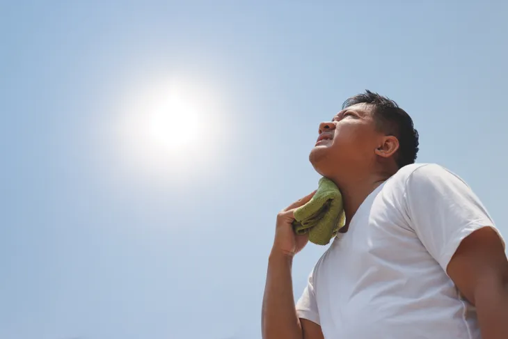 Man feeling hot in the sun