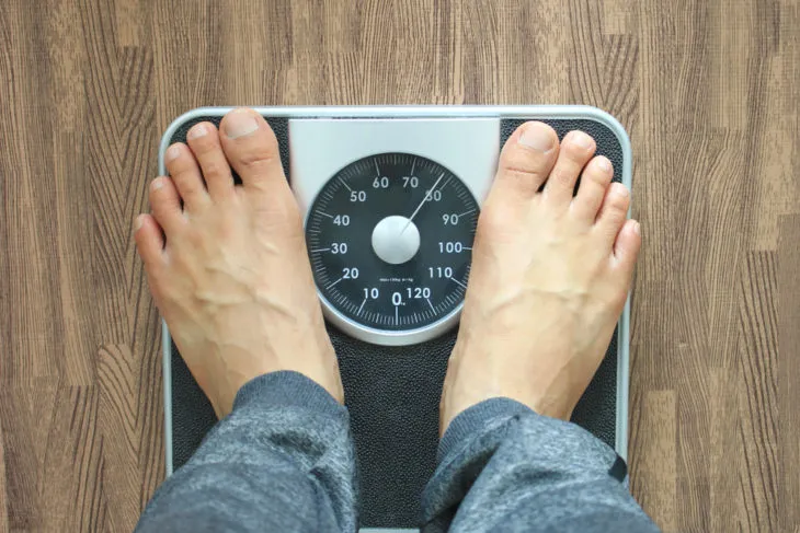 Person stepping on the scale to check their weight