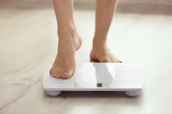 Stepping on a scale to check weight