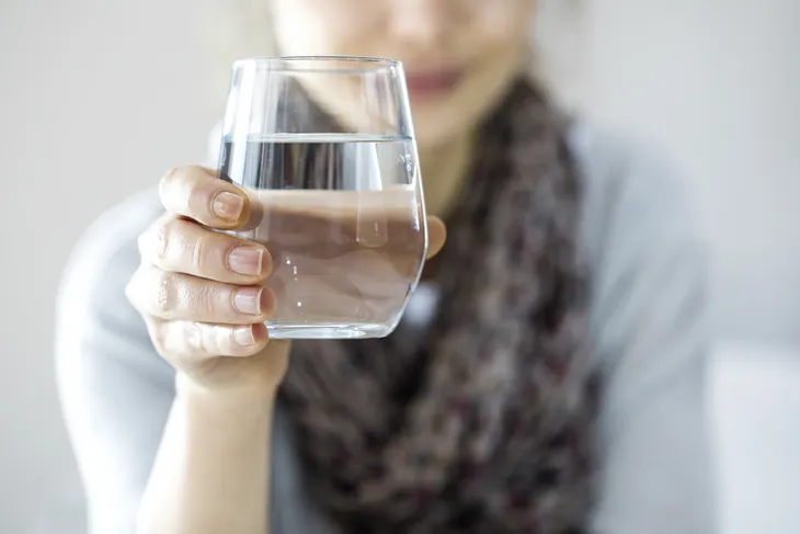 Woman holding a glass of water