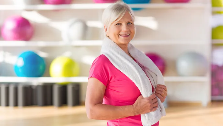 senior woman performing shoulder rolls