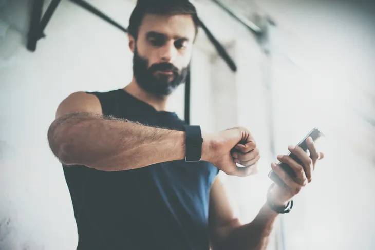 Man checking his watch at the gym