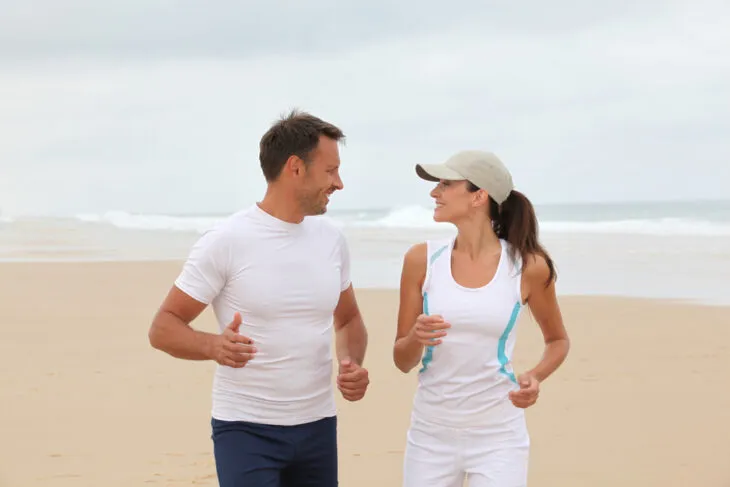 Mature healthy couple jogging on the beach